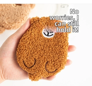 Close-up of a brown teddy fleece bear-shaped mini coin purse with embroidery
