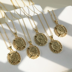 Detail of 18k gold plated brass oval alphabet pendant necklaces with vintage floral borders