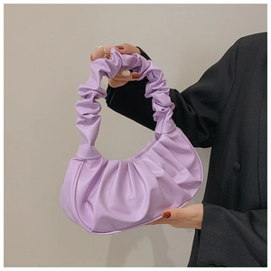 Detailed shot of purple ruched cloud bag handle and soft pleated PU leather texture