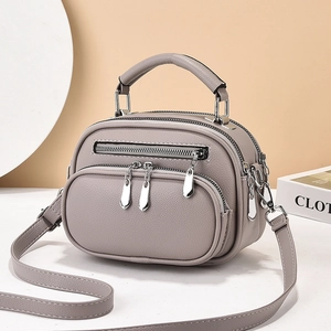 Grey multi-zipper PU leather crossbody bag with top handle and adjustable shoulder strap