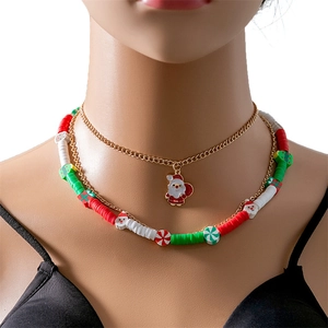 Close-up of layered Christmas necklace with Santa charms and colorful clay beads on model