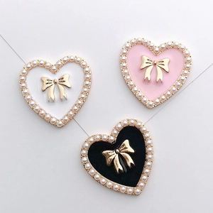 Elegant heart-shaped alloy charms with pearls and golden bows in black white and pink