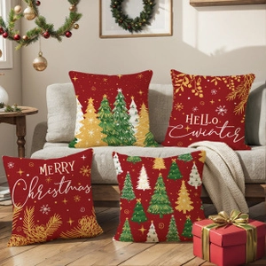 Detailed view of four festive Christmas pillow covers in red and green on a sofa