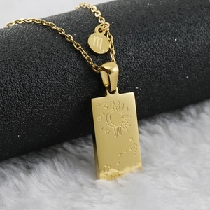 Macro shot of 18K gold plated stainless steel Scorpio necklace with celestial pendant