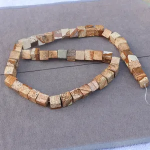 Macro detail of square natural picture jasper beads with earthy landscape textures
