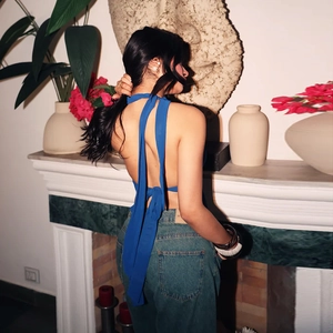Detail of blue halter neck crop top showing adjustable back ties and backless design