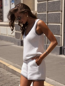 Detailed knit texture of white sleeveless U-neck top and shorts with grey contrast trim