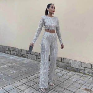Outdoor street style shot of silver sequin fringe two-piece set with wide-leg pants
