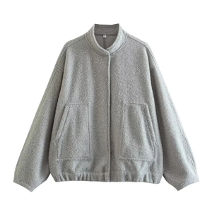 Detailed macro shot of light gray textured wool jacket collar and snap button closure