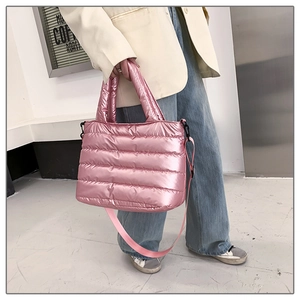 Detailed view of pink metallic quilted puffer tote bag with matching fabric shoulder strap