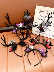 Detail view of four Halloween headbands featuring antlers, bats, and ghosts on leather surface
