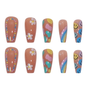 Detail view of rainbow dots and smiley face patterns on glossy press-on nails