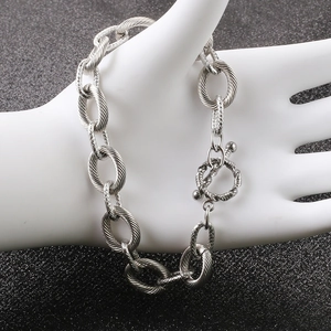 Detail view of silver textured link bracelet featuring a classic OT toggle closure design