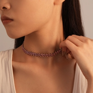 Detail view of pink crystal choker with dense rhinestone weaving and refined texture