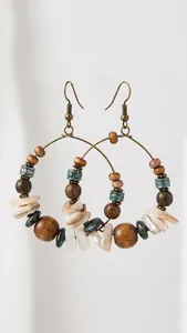 Detailed close-up of Bohemian beaded earrings with wooden beads and bronze rings