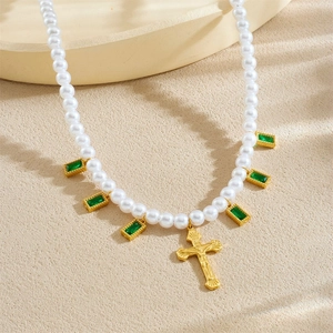 Vintage gold-plated pearl necklace with green crystals and a cross pendant charm