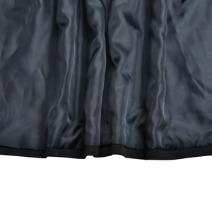 Close-up of soft dark gray blazer fabric texture with black piped edge and natural folds