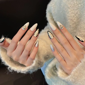 Luxury long stiletto press-on nails with marble texture, silver glitter, and crystals