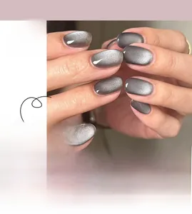 Detail of silver grey cat eye press-on nails in oval shape with magnetic shimmer effect