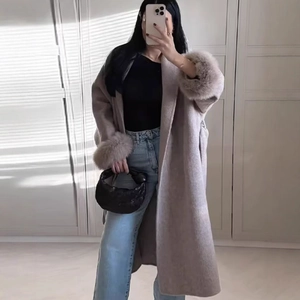 Women's long light brown wool coat with faux fur collar and cuffs in mirror selfie