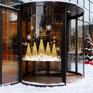 Golden Christmas tree stickers with Merry Christmas lettering on glass revolving doors