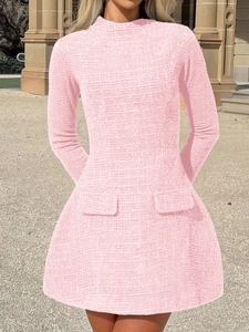 Detail view of the pink tweed fabric texture and high-neck design of this long-sleeved dress