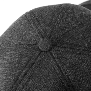 Macro detail of high-quality wool blend fabric and crown button on winter baseball cap