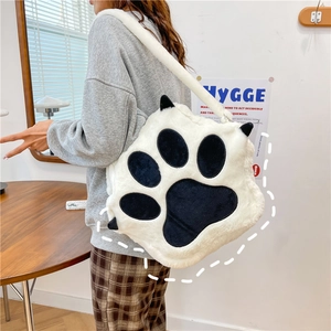 Plush cat paw backpack in black and white faux fur, versatile crossbody and shoulder bag