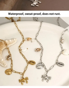 Detailed view of waterproof ocean necklaces with crab and seashell charms in gold and silver