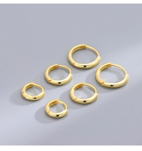 Detailed view of three pairs of S925 sterling silver gold-plated hoop earrings in varied sizes
