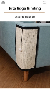 Macro shot of sisal fiber scratch pad with black edges protecting a blue fabric sofa corner