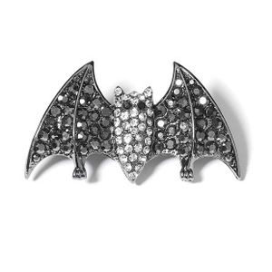 Detailed view of a bat brooch set with sparkling black and white rhinestones