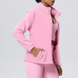 Detail view of pink fleece workout jacket with stand collar and seamless pockets for women