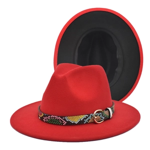Detail of red fedora hat with contrast black lining and gold buckle snake skin band