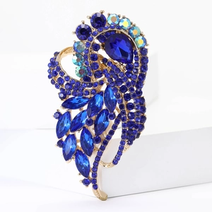Detailed macro view of high-end golden brooch with sparkling blue crystal rhinestones