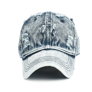 Vintage washed denim baseball cap with distressed rip details on a white background