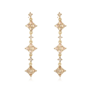 Detail of 18K gold plated drop earrings with champagne cubic zirconia and geometric tassels