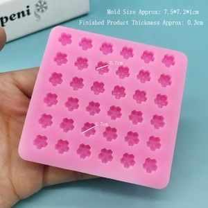 Close-up of pink silicone mold with 30 micro cherry blossom cavities for DIY nail art crafts