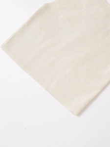 Detailed macro view of beige knit fabric texture and high-quality weaving pattern