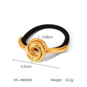 Macro view of gold metal swirl knot hair tie with size dimensions 5.31cm and 2.49cm