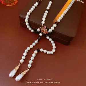 Vintage teardrop flower necklace with layered pearls and crystal tassel accents