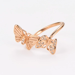 Close-up of rose gold butterfly ring featuring intricate crystal-set wing details