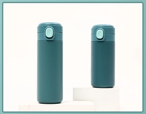 Macro view of matte dark teal pea cups with bounce lids in two sizes on a white stand
