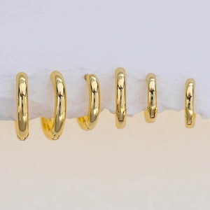 Polished 18K gold-plated hoop earrings set in six various sizes on textured display