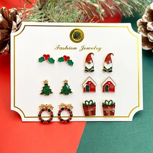 Christmas stud earring set featuring reindeer, snowflakes and Santa Claus on festive card