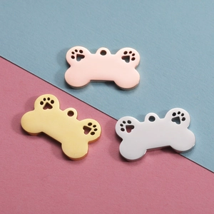 Titanium steel bone-shaped pet pendants in gold, silver, and rose gold with hollow paw prints