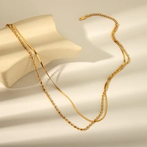 Detail shot of golden double-layer stainless steel snake chain and beaded necklace set