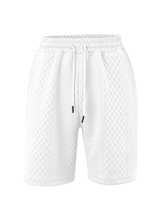 Detailed macro view of white men's shorts showing textured jacquard knit and drawstring waist