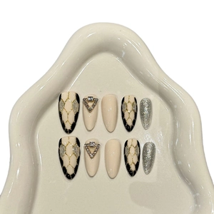 Luxury almond press-on nails with snake pattern, grey cat eye effect, and rhinestones