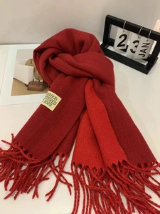 Red color-block cashmere-feel scarf with fringe and minimalist label on white surface